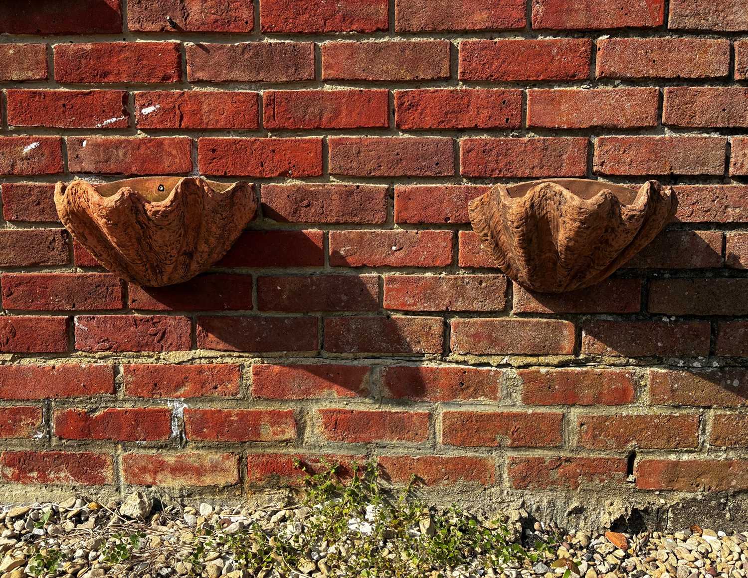 Lot 1351 - A pair of cast terracotta wall pockets